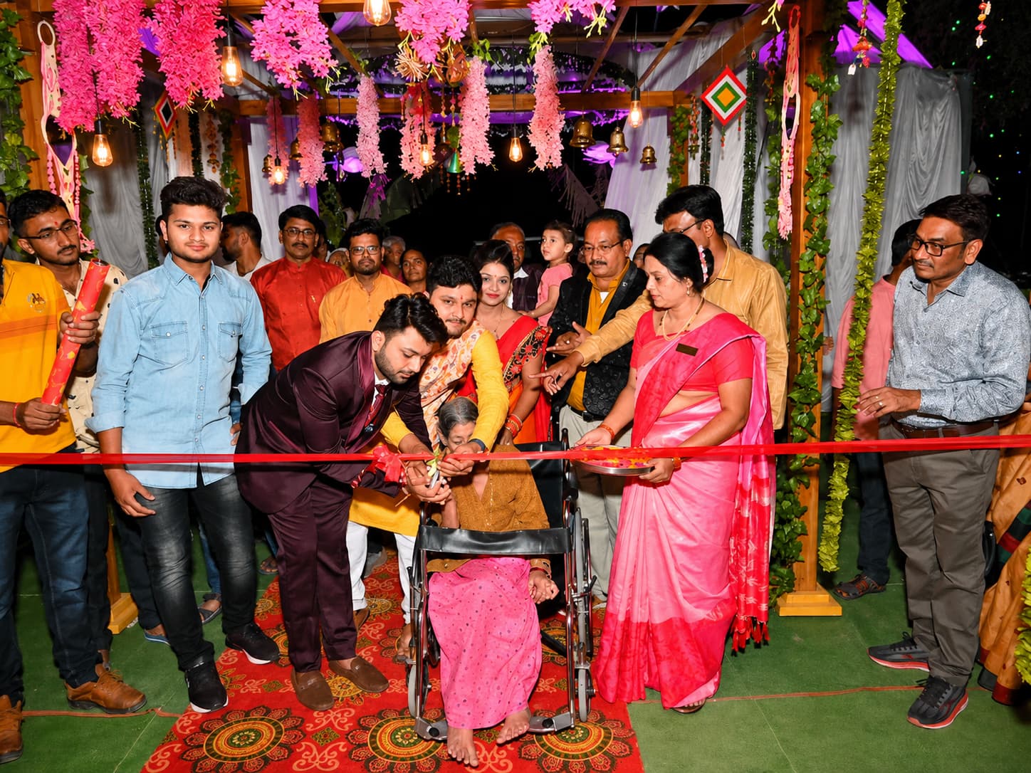 Kamalabai Mahadeorao Fuladi cutting the ribbon at the Lotus Inn inauguration